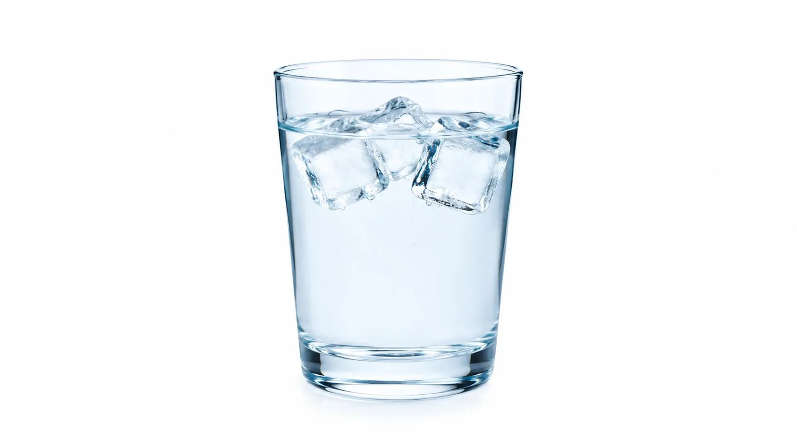 A clear glass filled with cold water and three melting ice cubes on a white background.